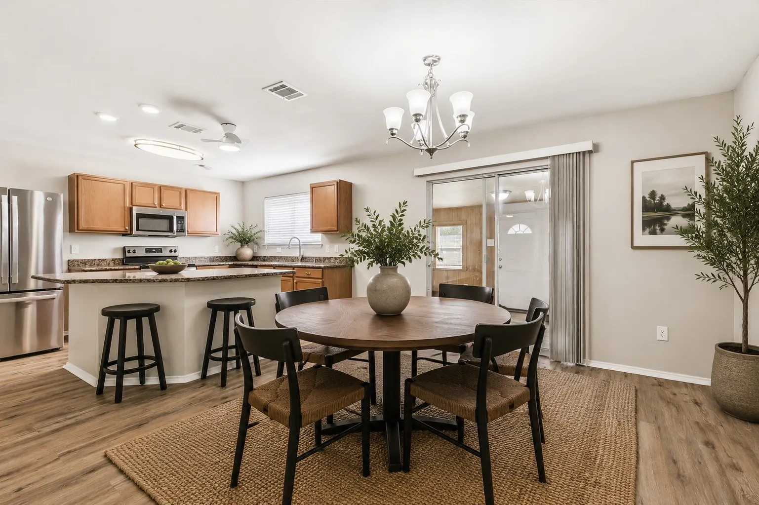 Kitchen featuring stainless steel appliances, wood-finish cabinetry, and a peninsula with countertop seating