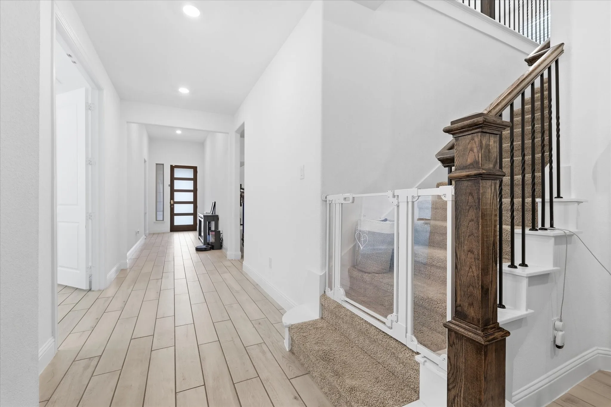 Wood-finish flooring throughout the hallway