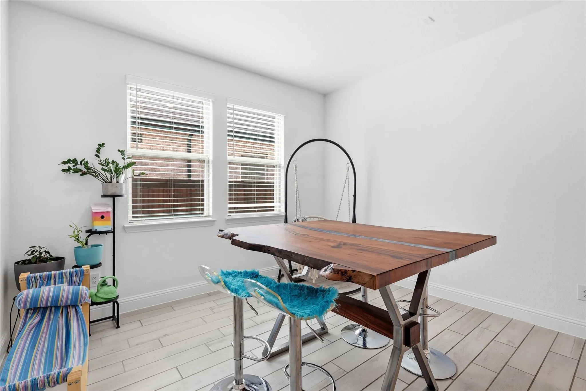 White walls, light wood-finish flooring, and white window frames