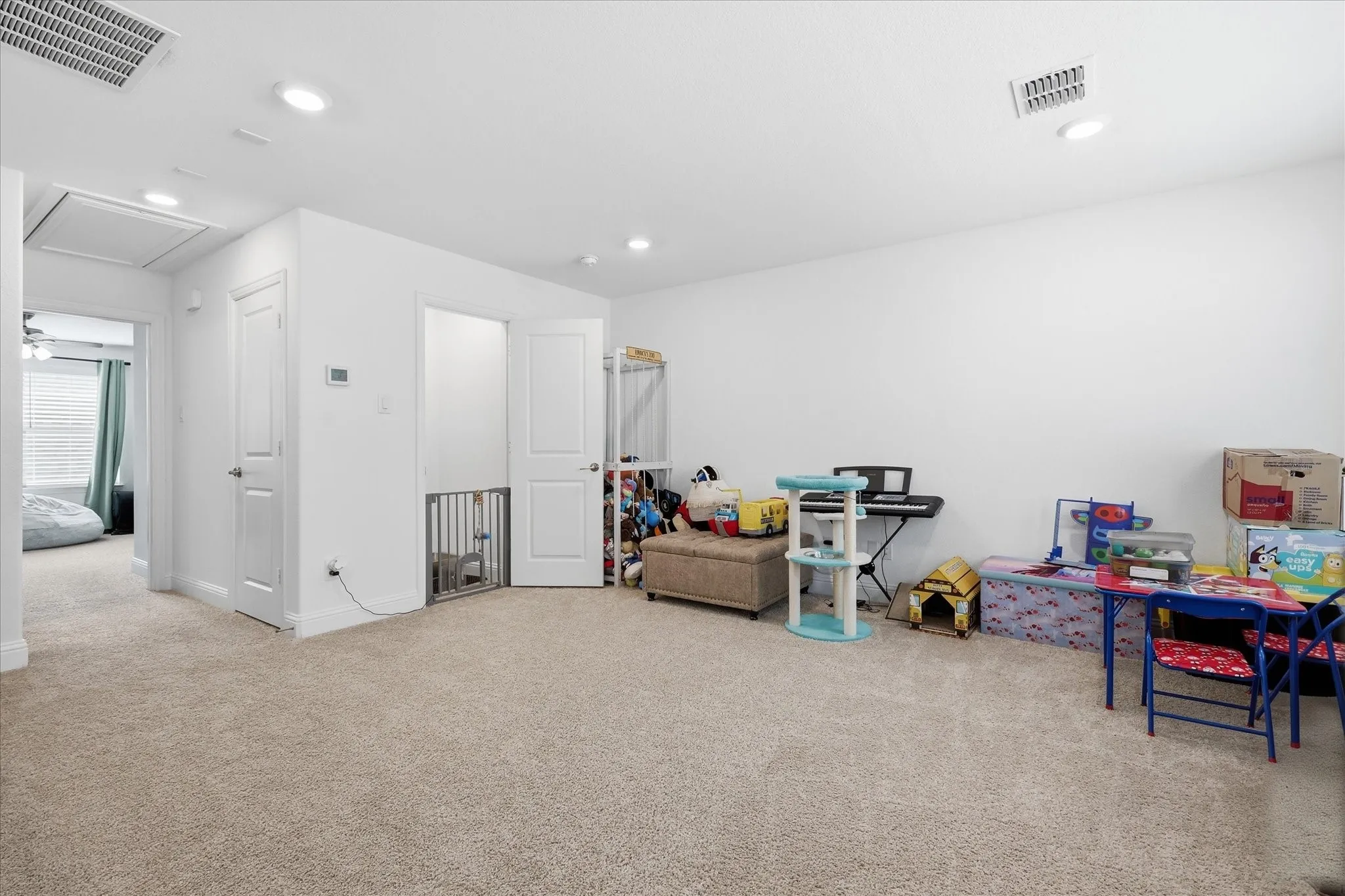 Recessed lighting, white walls, and carpeted flooring