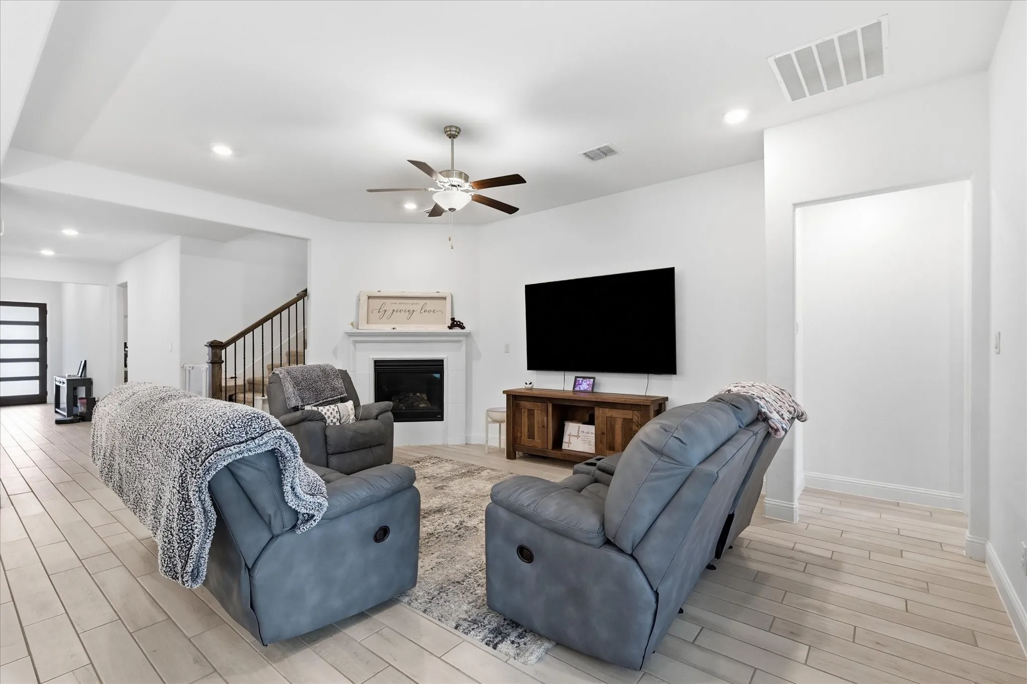 White walls with recessed lighting and a ceiling fan
