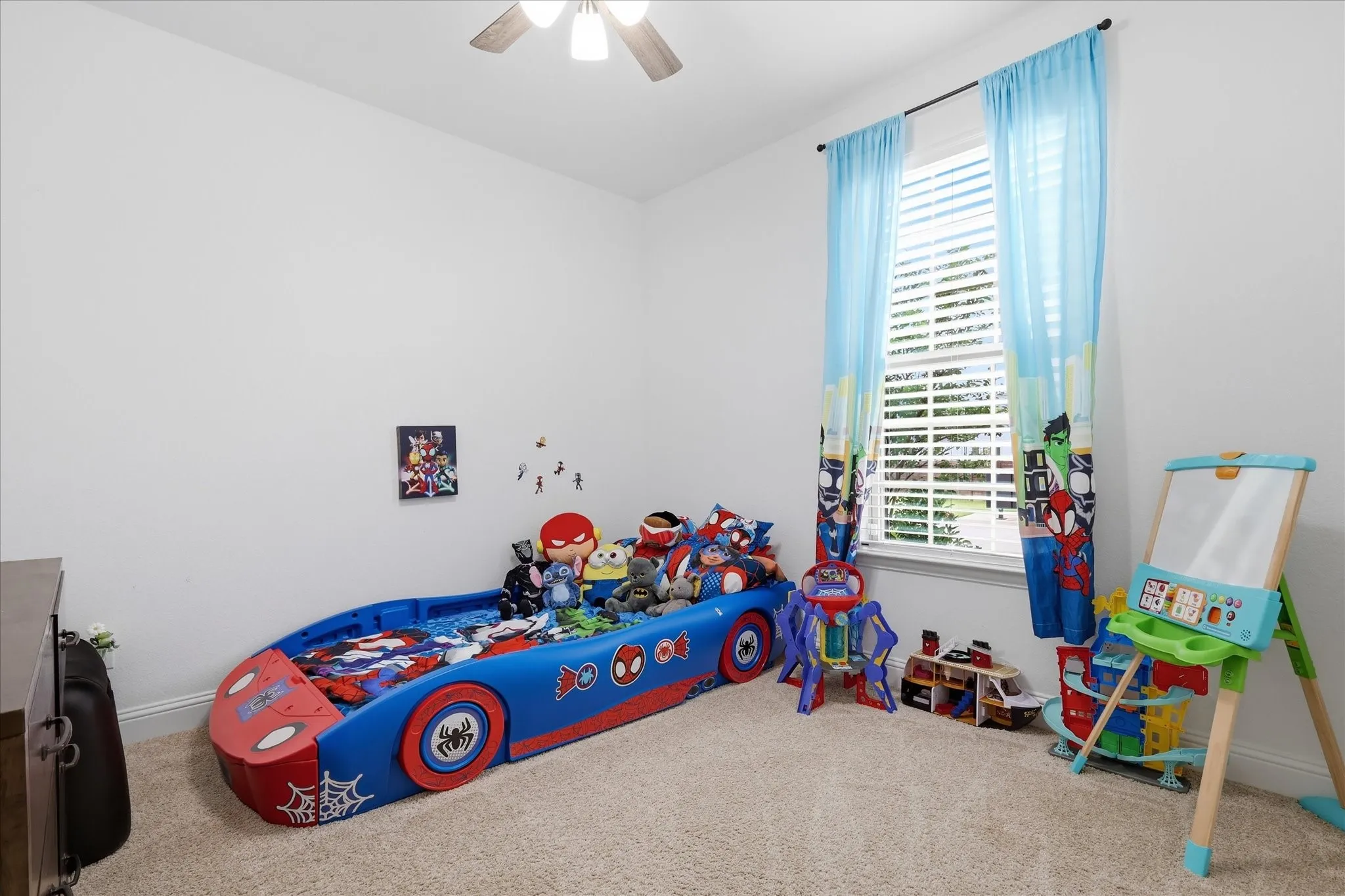 Carpeted room with a ceiling fan, a window with horizontal blinds, and smooth white walls