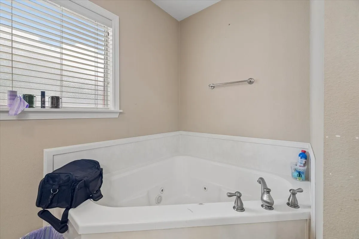 Spacious walk-in closet complete with built-in organizational shelving and double hanging rods.