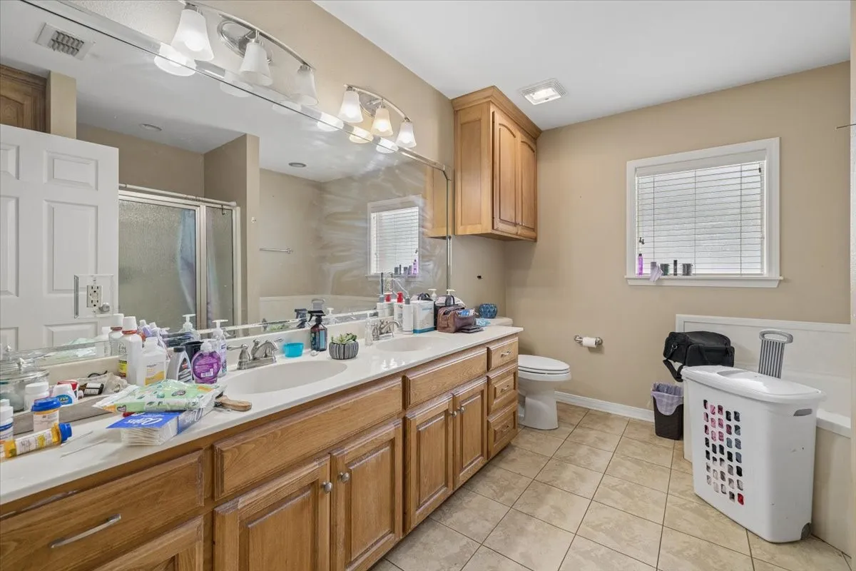 Primary bathroom boasting an expansive double vanity with plenty of drawer storage.