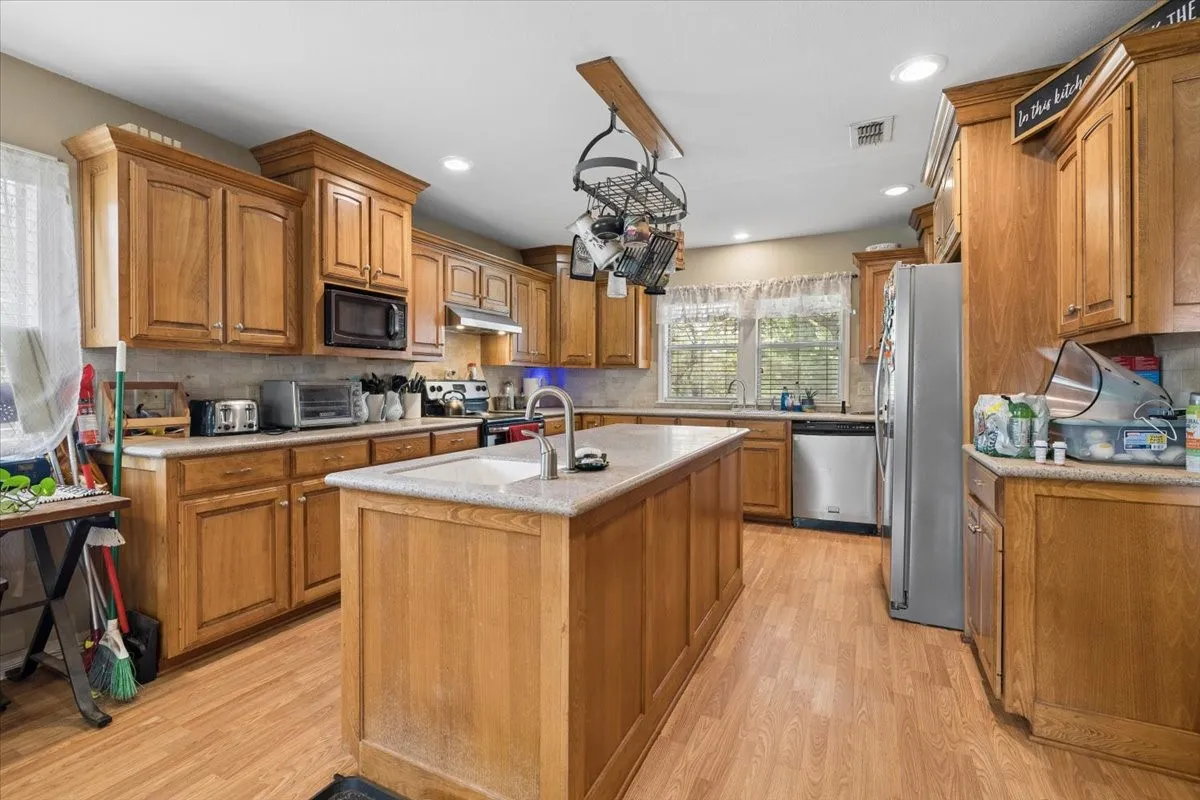 Bright kitchen area highlighting a generous center island and updated fixtures.