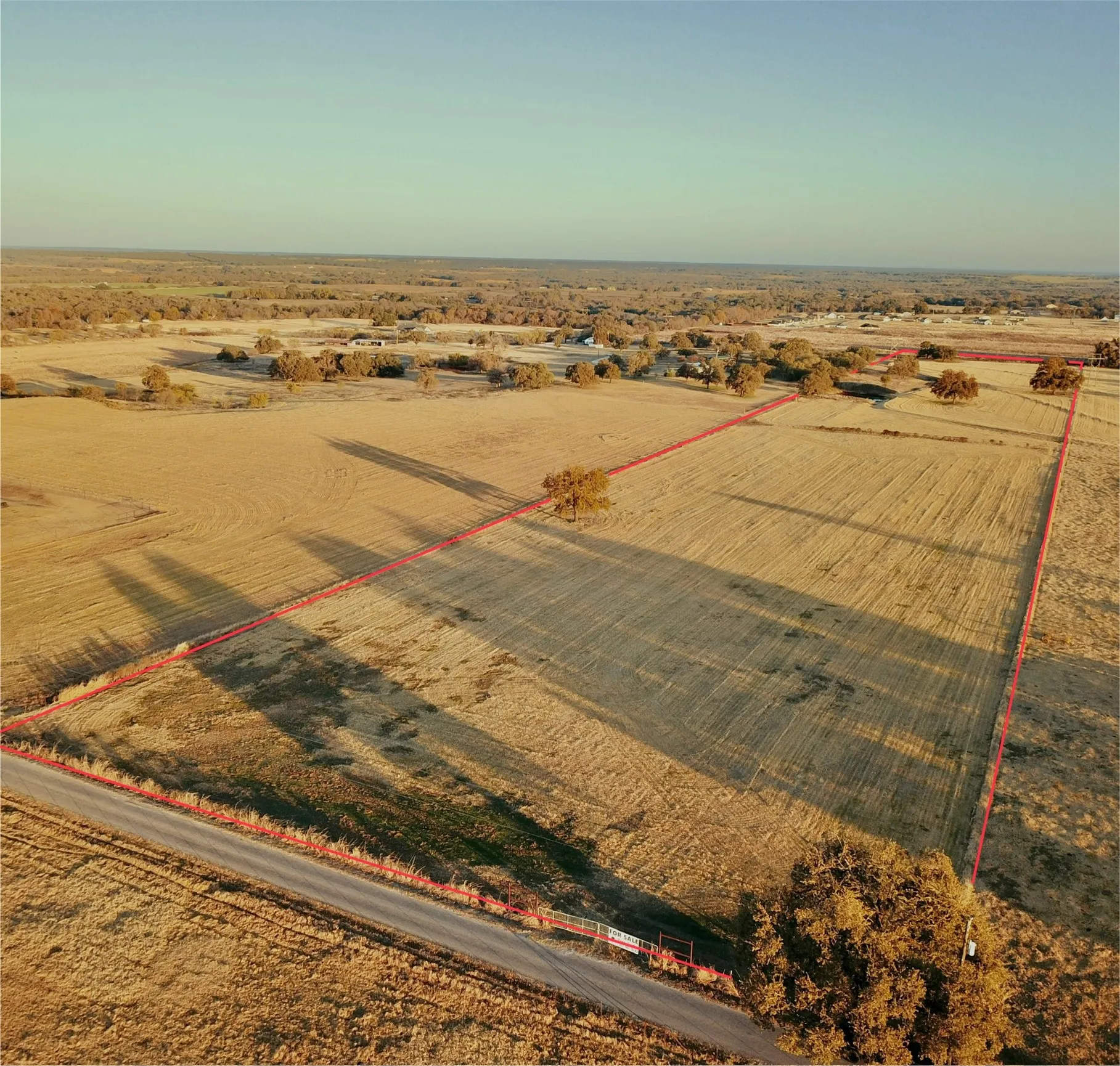 Expansive land parcel featuring open fields and scattered trees