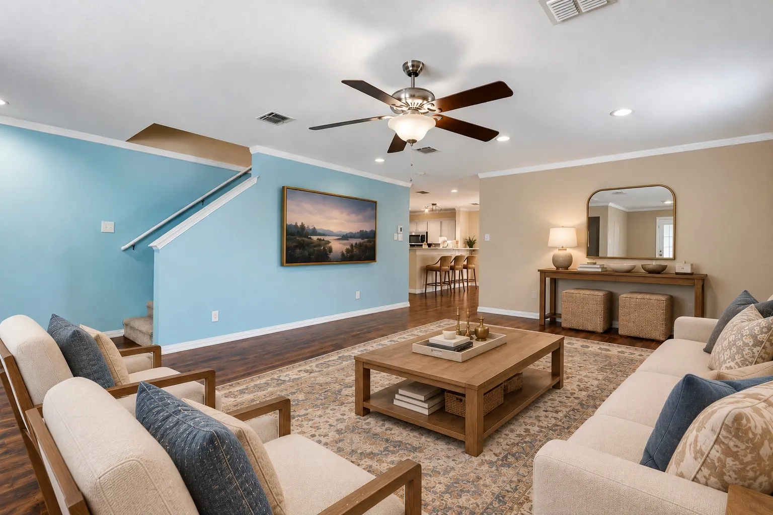 Spacious living area featuring wood-finish flooring, recessed lighting, and a ceiling fan