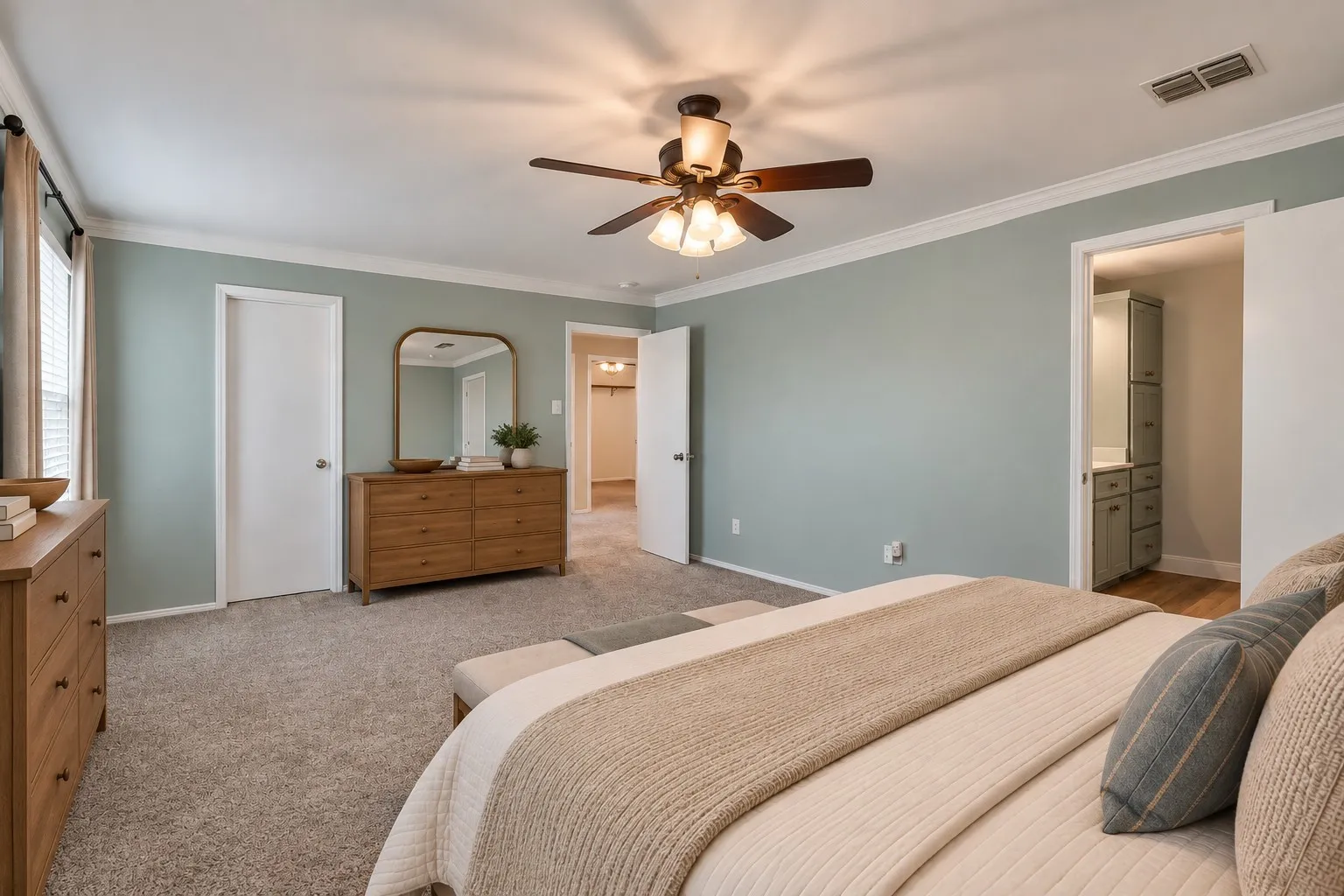 Ceiling fan with integrated lighting, crown molding, double window, and carpeted flooring