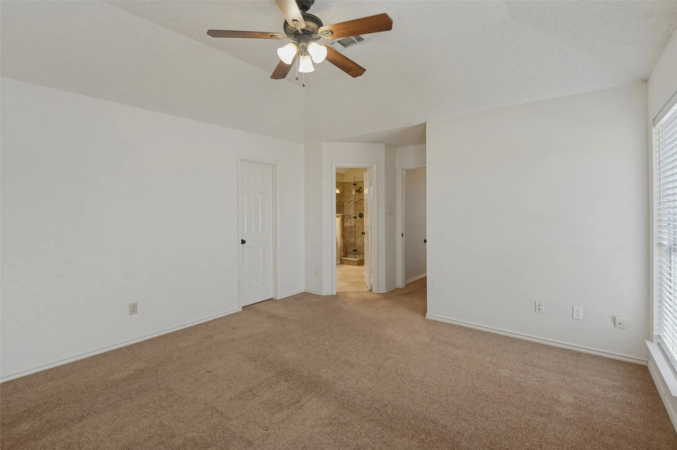 Vaulted ceiling with a ceiling fan, carpet flooring, and window with blinds