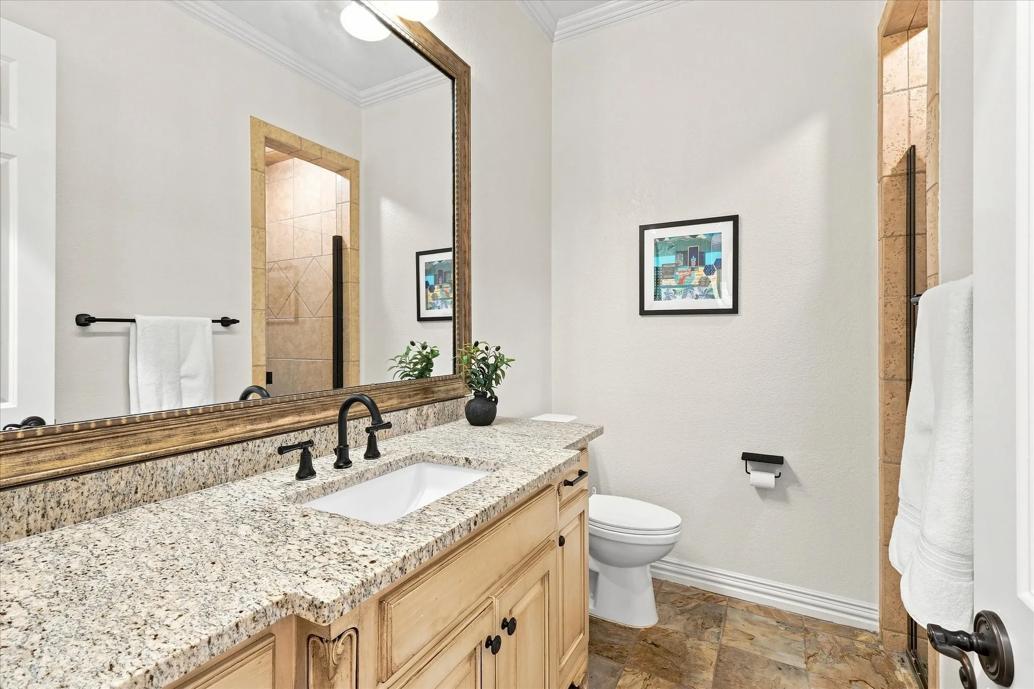 Granite countertop vanity with integrated sink and matte black fixtures