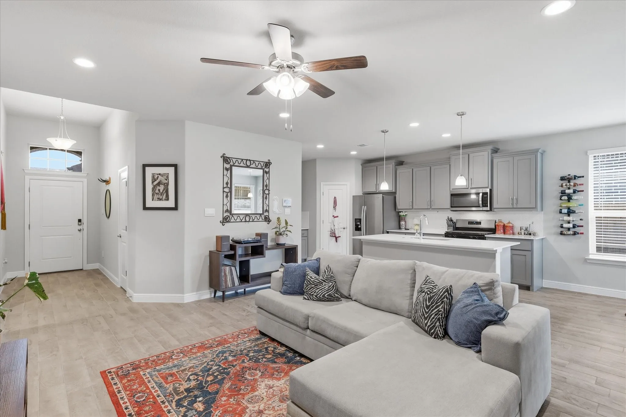 Open-concept living area with wood-finish flooring, recessed lighting, and a ceiling​​‌​​​​‌​​‌‌​‌‌​​​‌‌​‌​‌​‌​​​‌​​ fan