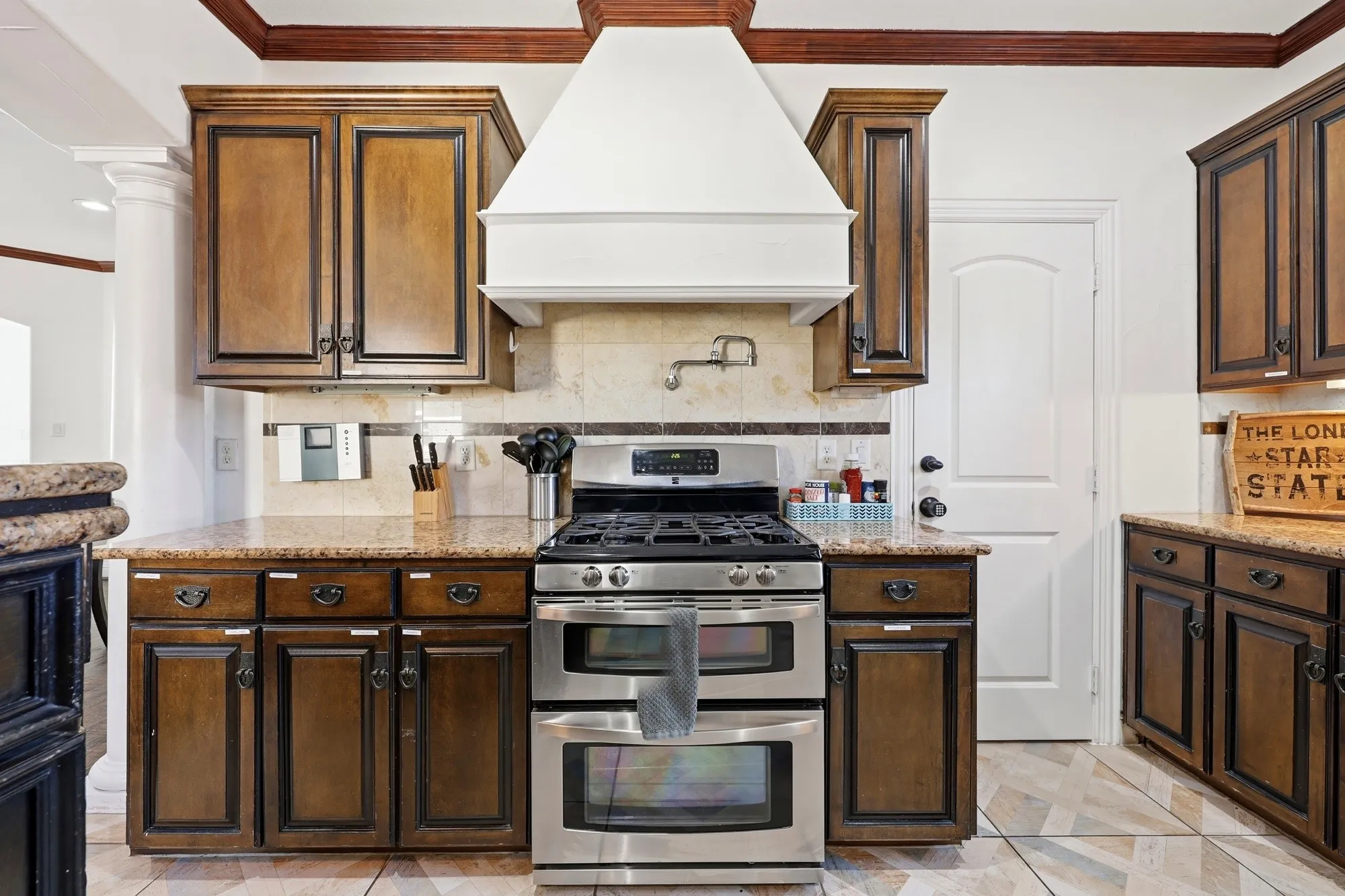 Kitchen on level 2 with gas stove, double oven and pot filler