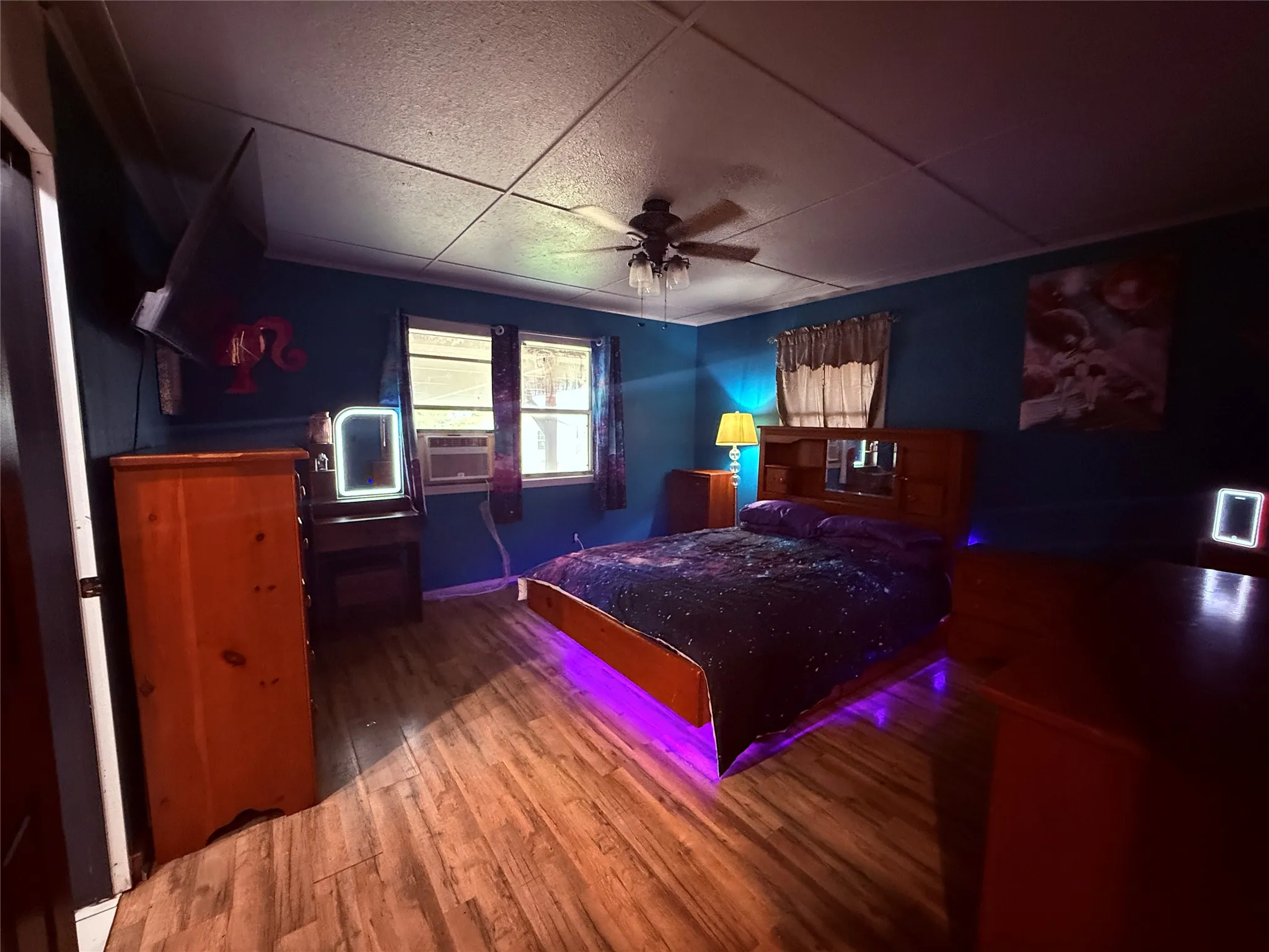 Wood-finish flooring, ceiling fan, and multiple windows