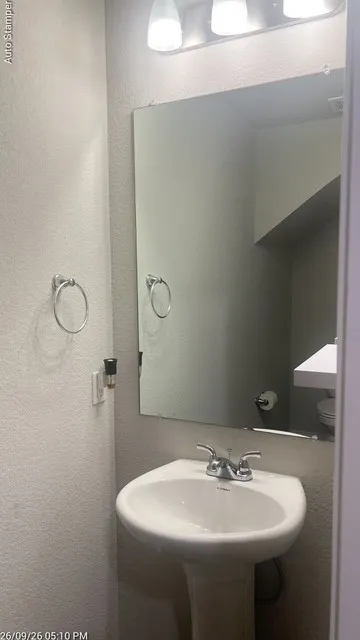 White pedestal sink with a chrome faucet