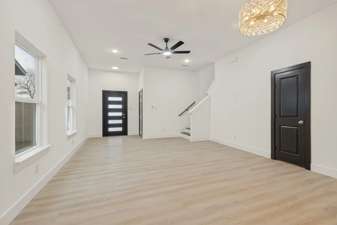Wood-finish flooring, recessed lighting, modern ceiling fan, contemporary front door with horizontal lites, and a decorative ceiling fixture
