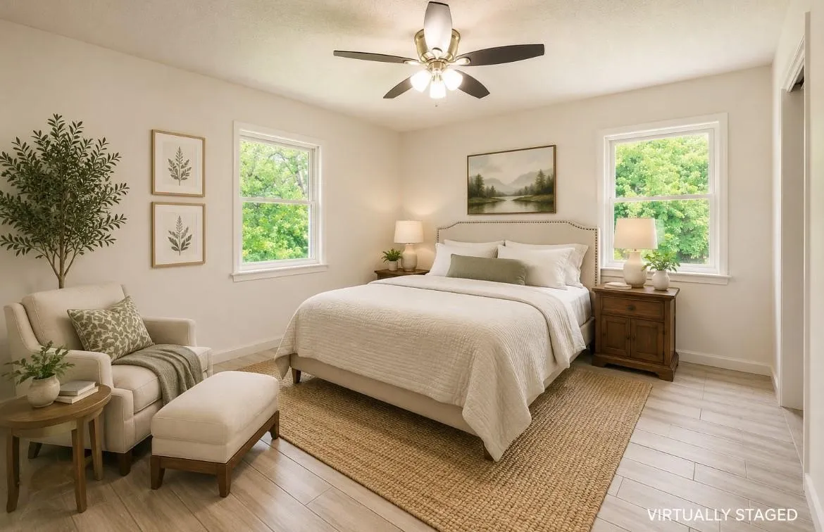 Light wood-finish flooring with an area rug, dual windows, and a ceiling fan with integrated lighting