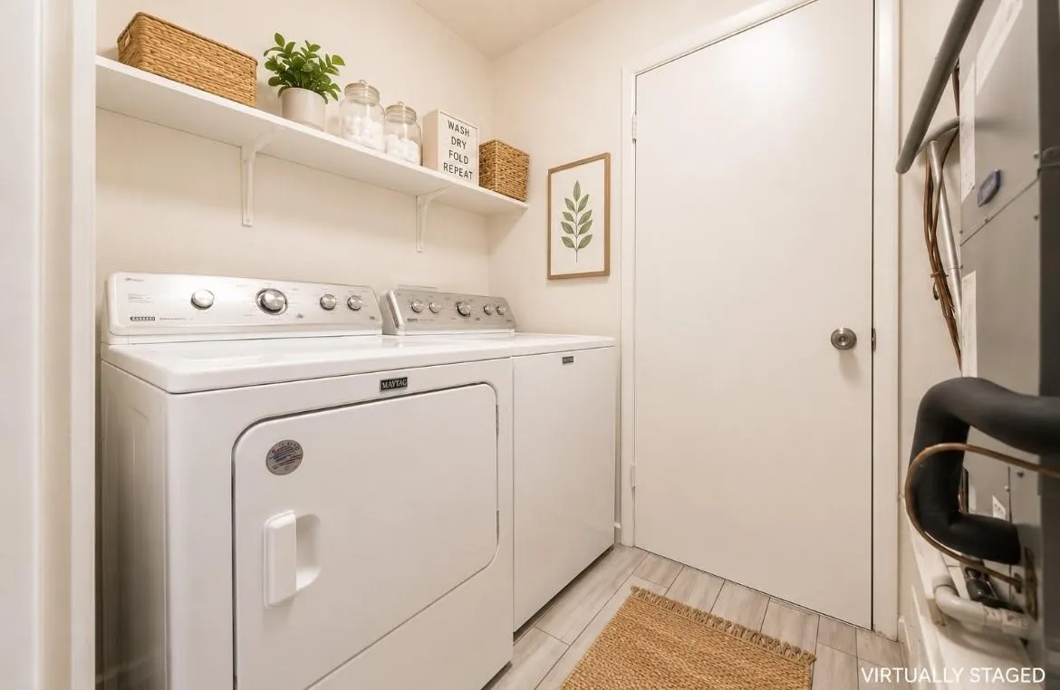 Laundry area with white upper shelving, wood-finish flooring, and white walls