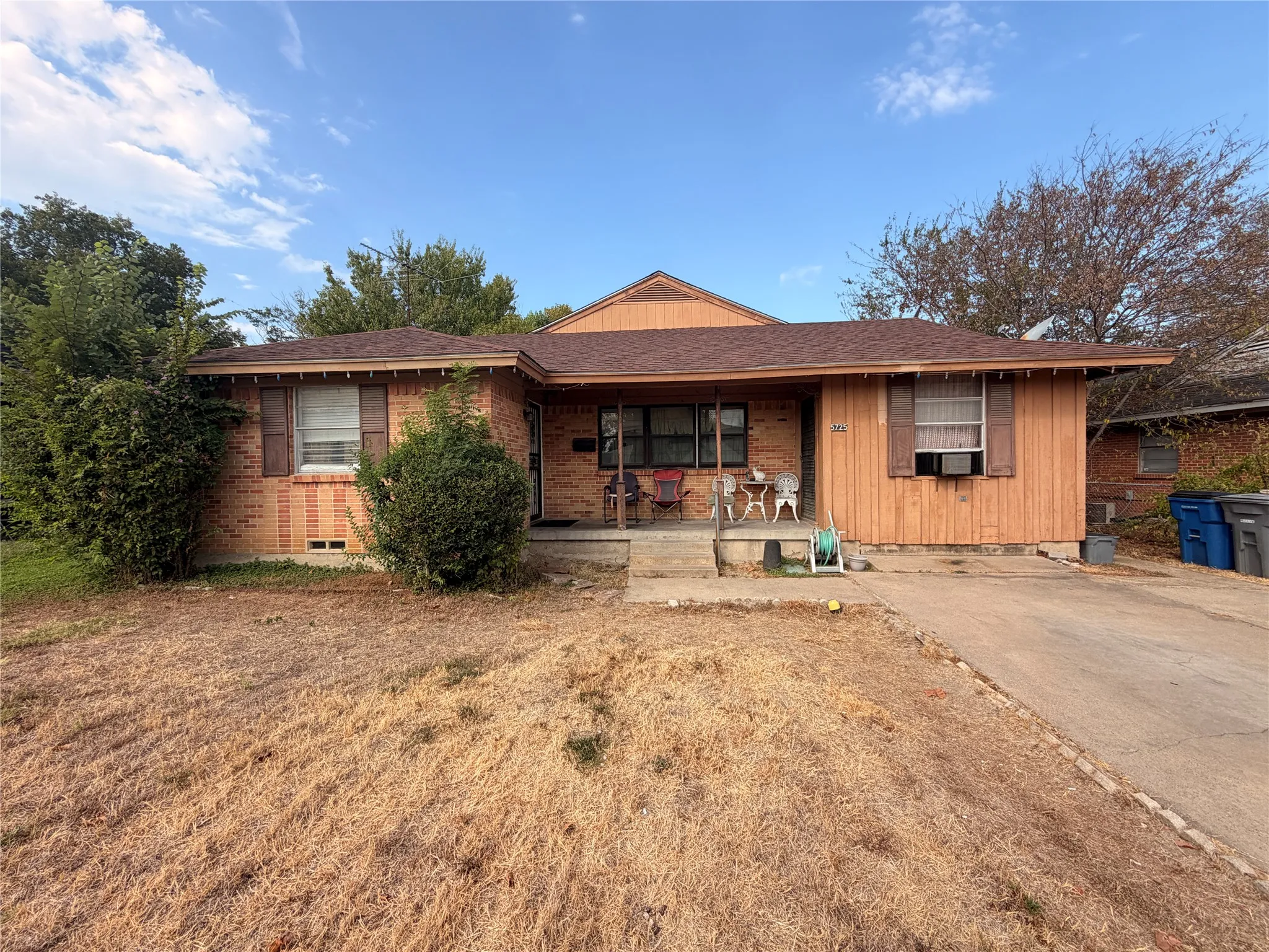 Brick and wood-sided exterior with a brown shingle roof