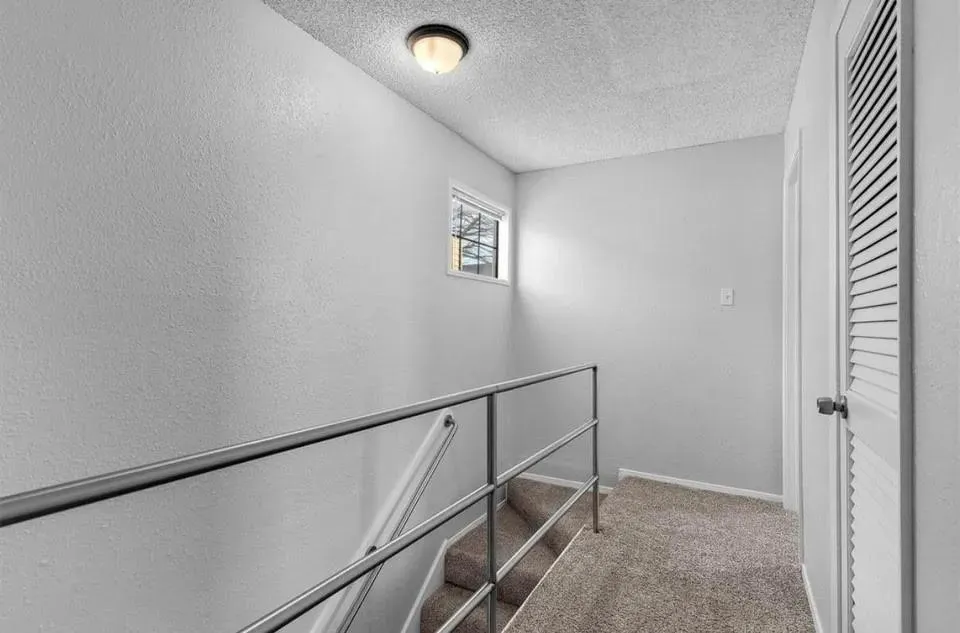 A well-lit second floor hallway