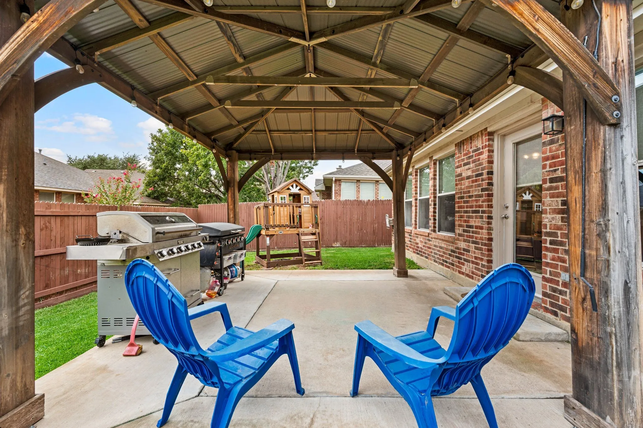 Covered patio with a metal roof and exposed wood beams