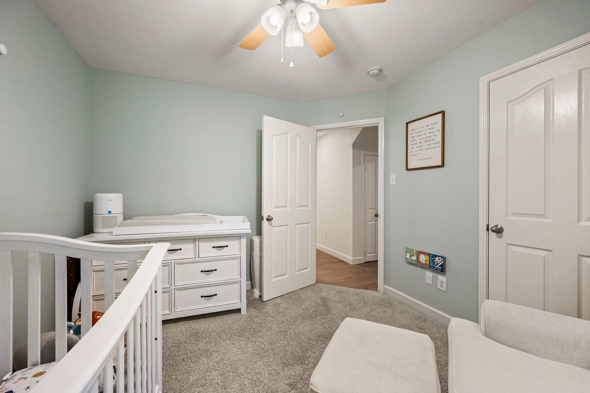 Recessed ceiling, neutral carpet flooring, ceiling fan, and white paneled doors