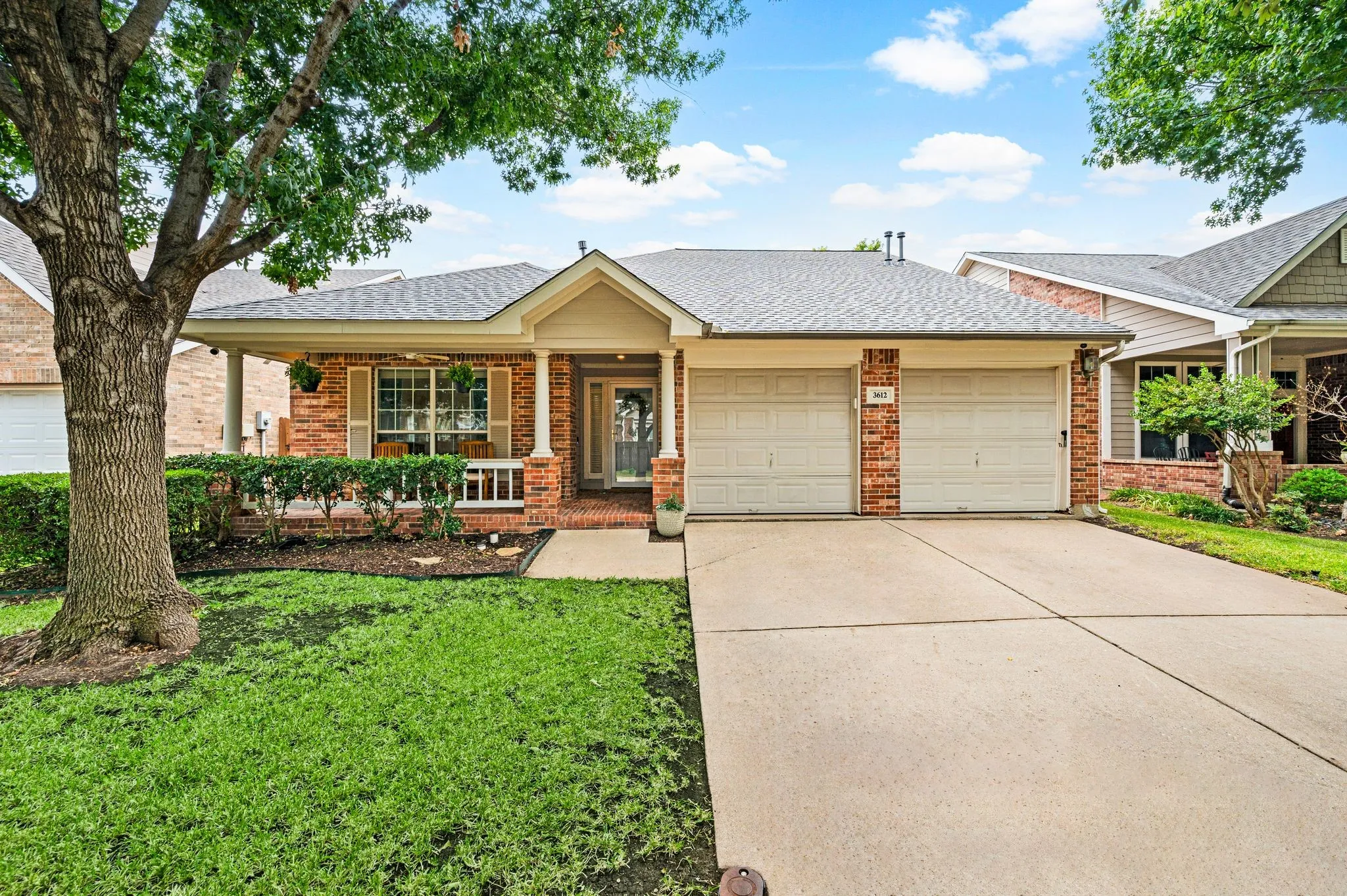 Brick exterior with a covered front porch featuring white railings