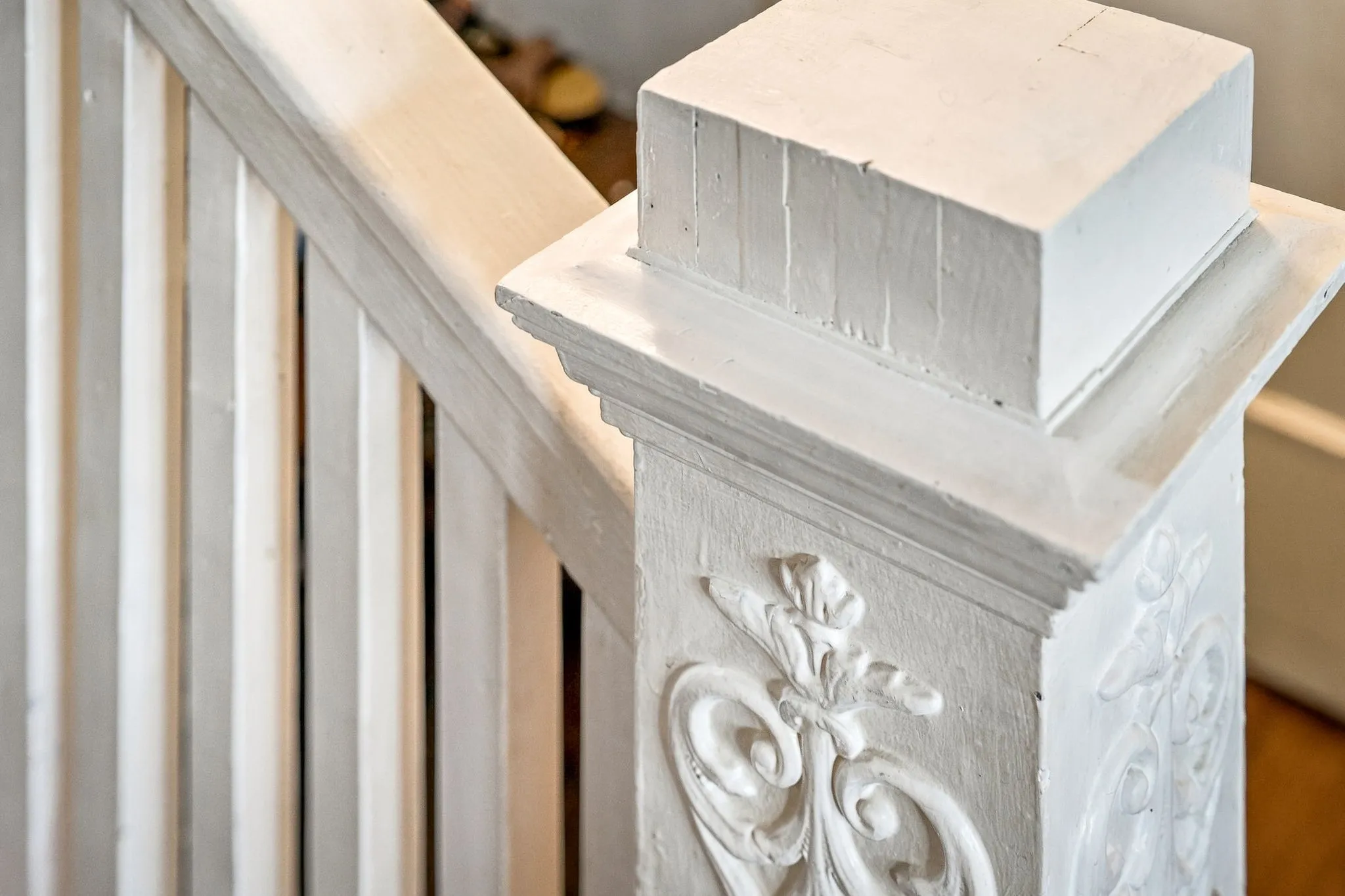 White painted banister with decorative newel post