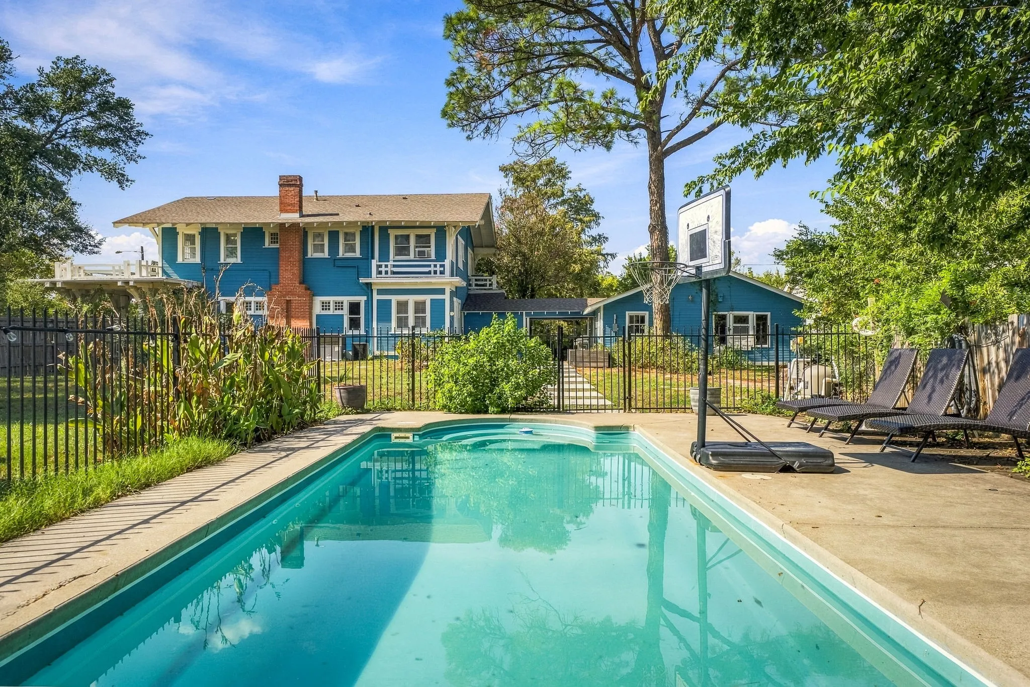 In-ground swimming pool with concrete surround