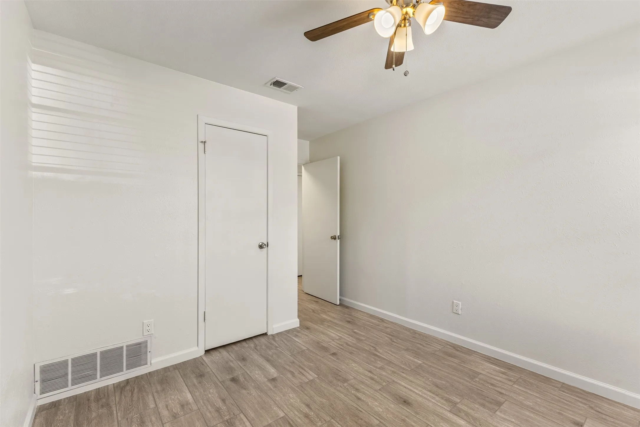 Wood-finish flooring with white walls