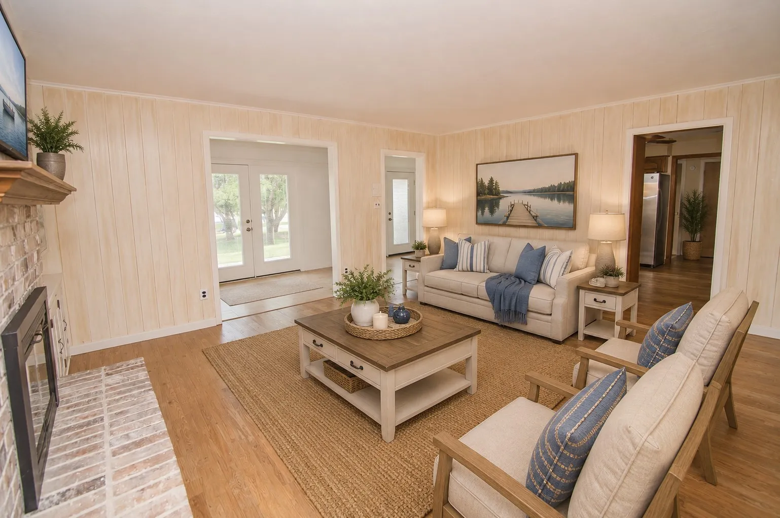 Wood-finish flooring throughout, featuring a brick fireplace with a wood mantle