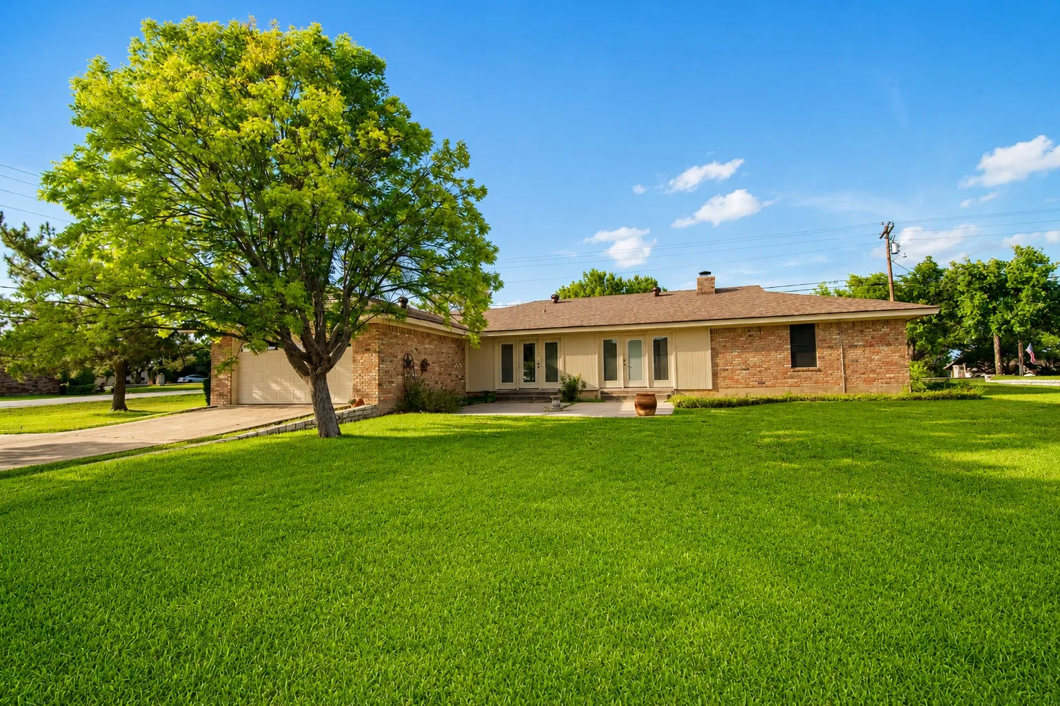 Brick and stucco exterior with a hip roof and chimney