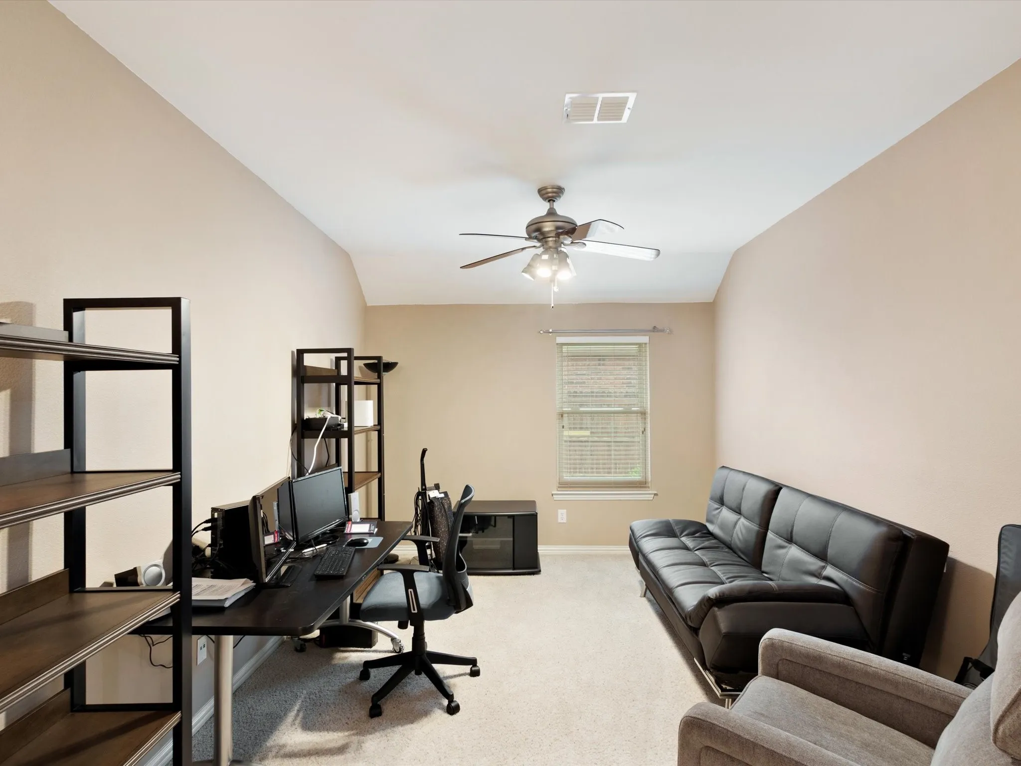 Vaulted ceiling, ceiling fan with integrated lighting, window with blinds, and neutral wall tones