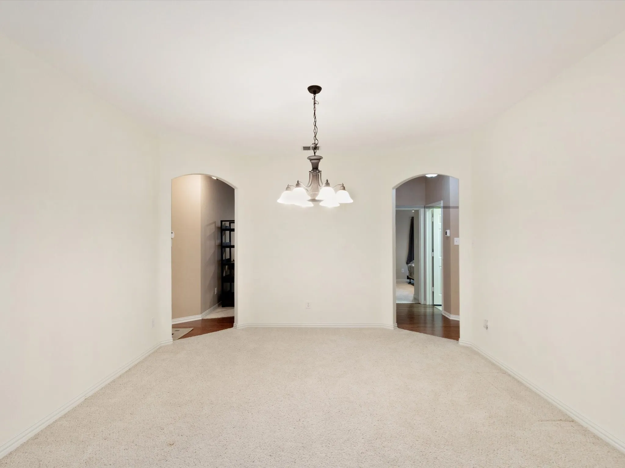 Archway entryways with wood-finish flooring