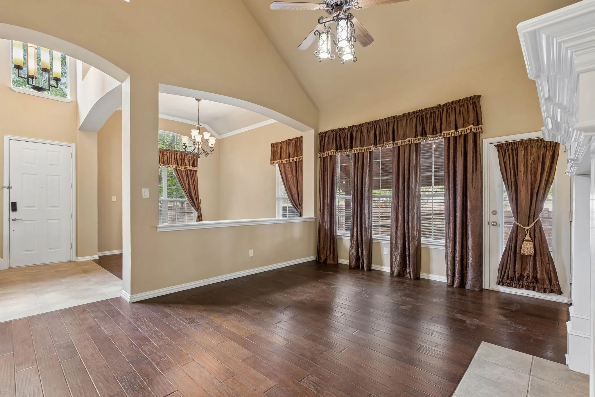 Vaulted ceilings, wood-finish flooring, and multiple arched doorways