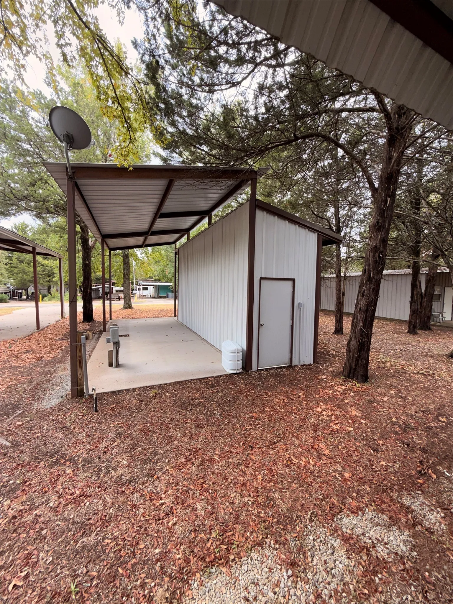Metal structure with an attached covered concrete patio and a single entrance door