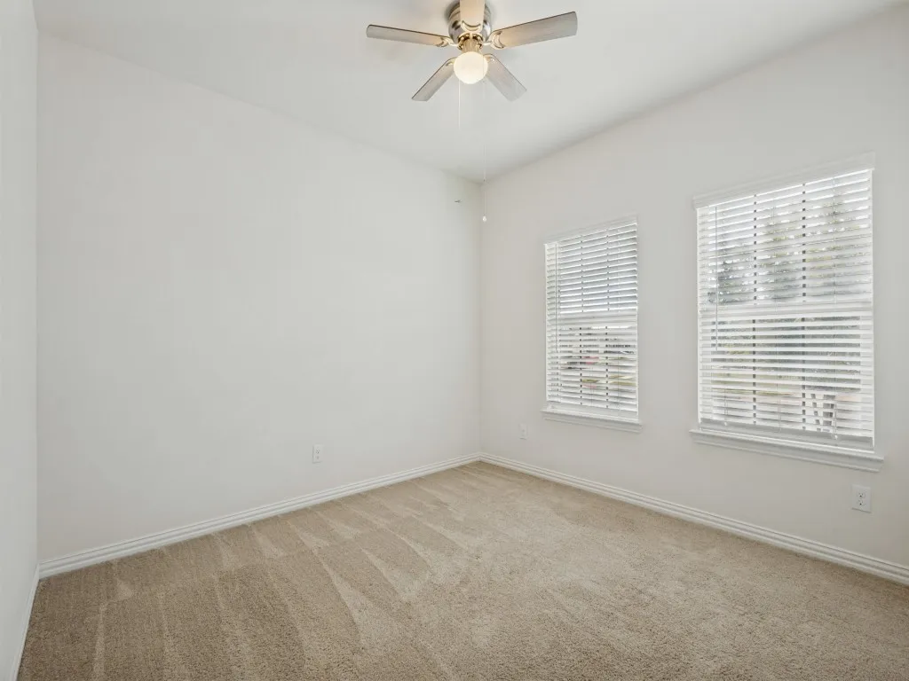 Two additional bedrooms in the front of the home with a full bathroom between. Ceiling fans in all bedrooms.