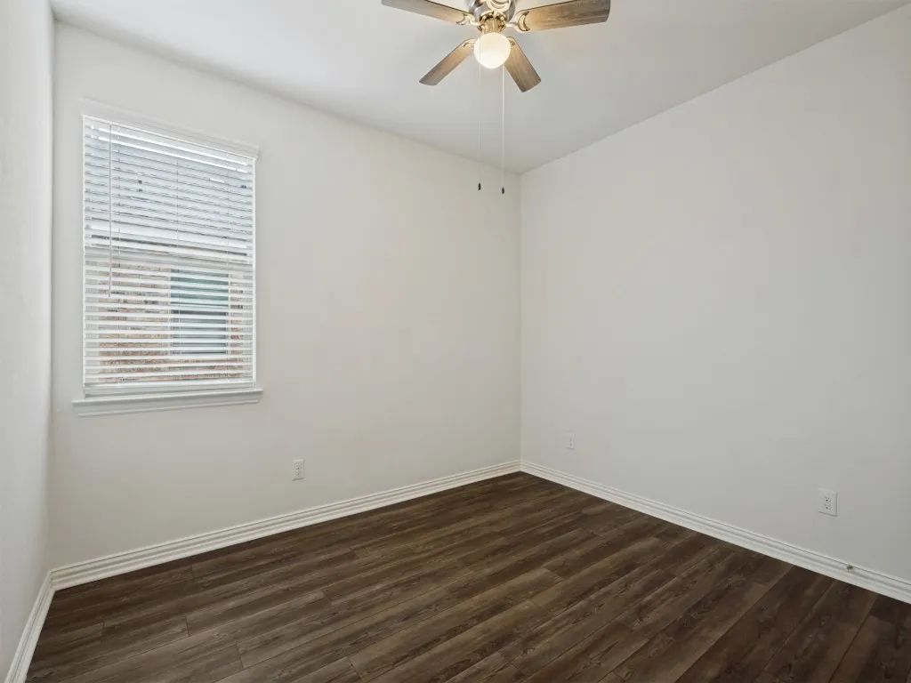 The fourth bedroom features the wood-look floors and makes a great home office or study if you only need three bedrooms!