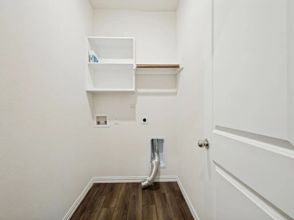 Good sized laundry room with shelving.