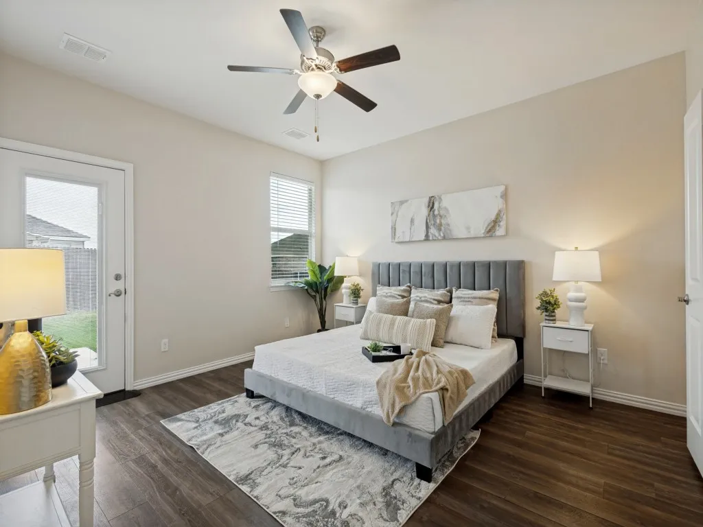 Primary bedroom is nice and spacious and offers a door direct to the backyard and patio.