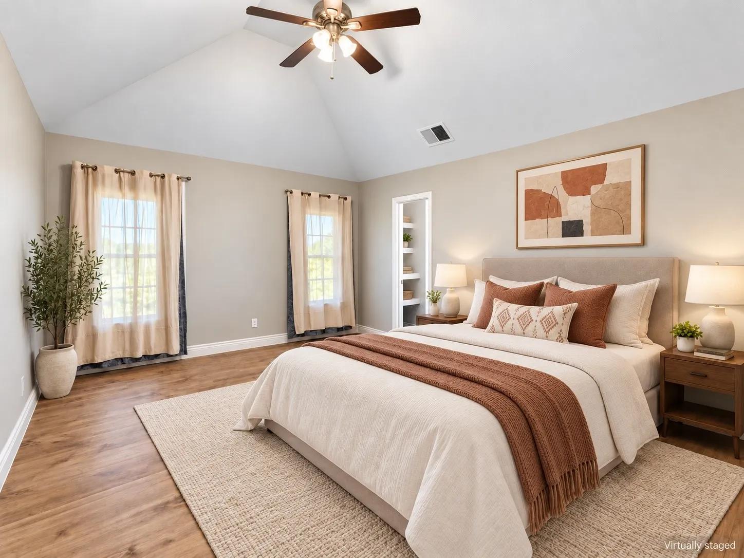 Vaulted ceiling with a ceiling fan, wood-finish flooring, and recessed built-in shelving