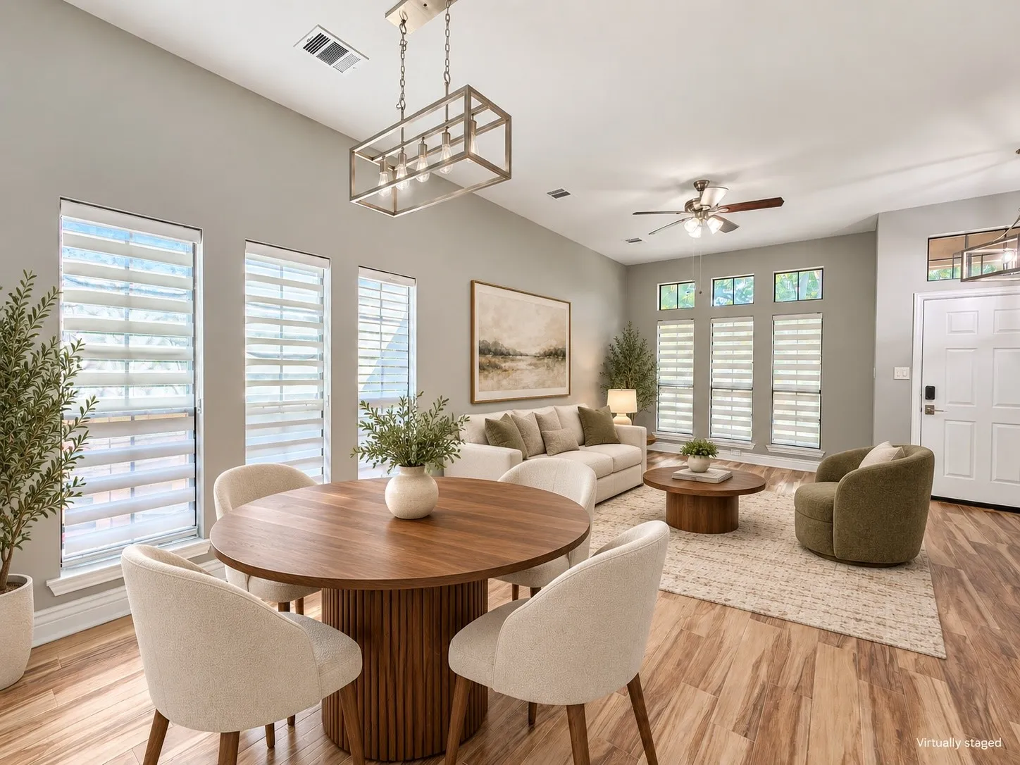 Wood-finish flooring throughout, vaulted ceiling, multiple windows with blinds, a ceiling fan, and a contemporary​​‌​​​​‌​​‌‌​‌‌​​​‌‌​‌​‌​‌​​​‌​​ chandelier