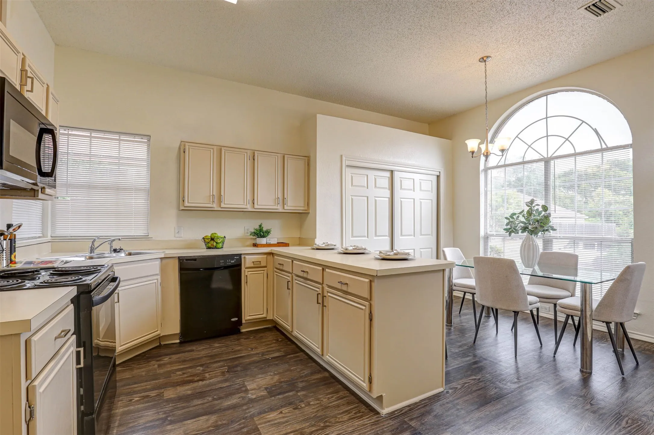 Sparkling kitchen featuring freshly refinished cabinets, abundant counter space, and an open flow to the breakfast area.