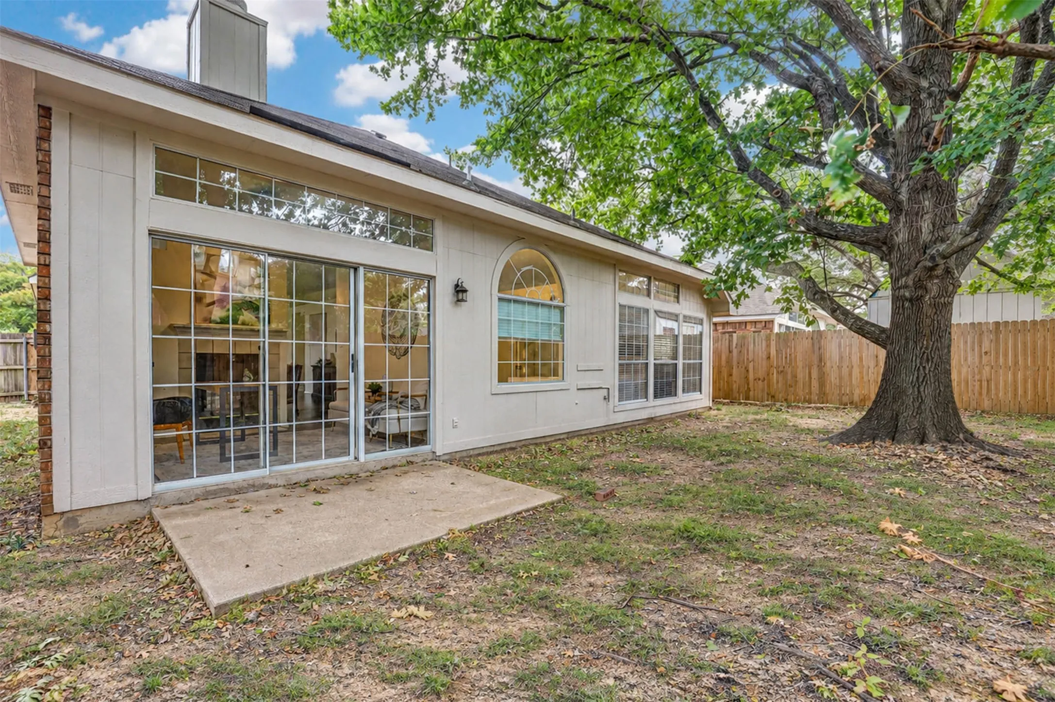Good sized backyard with large shade tree.