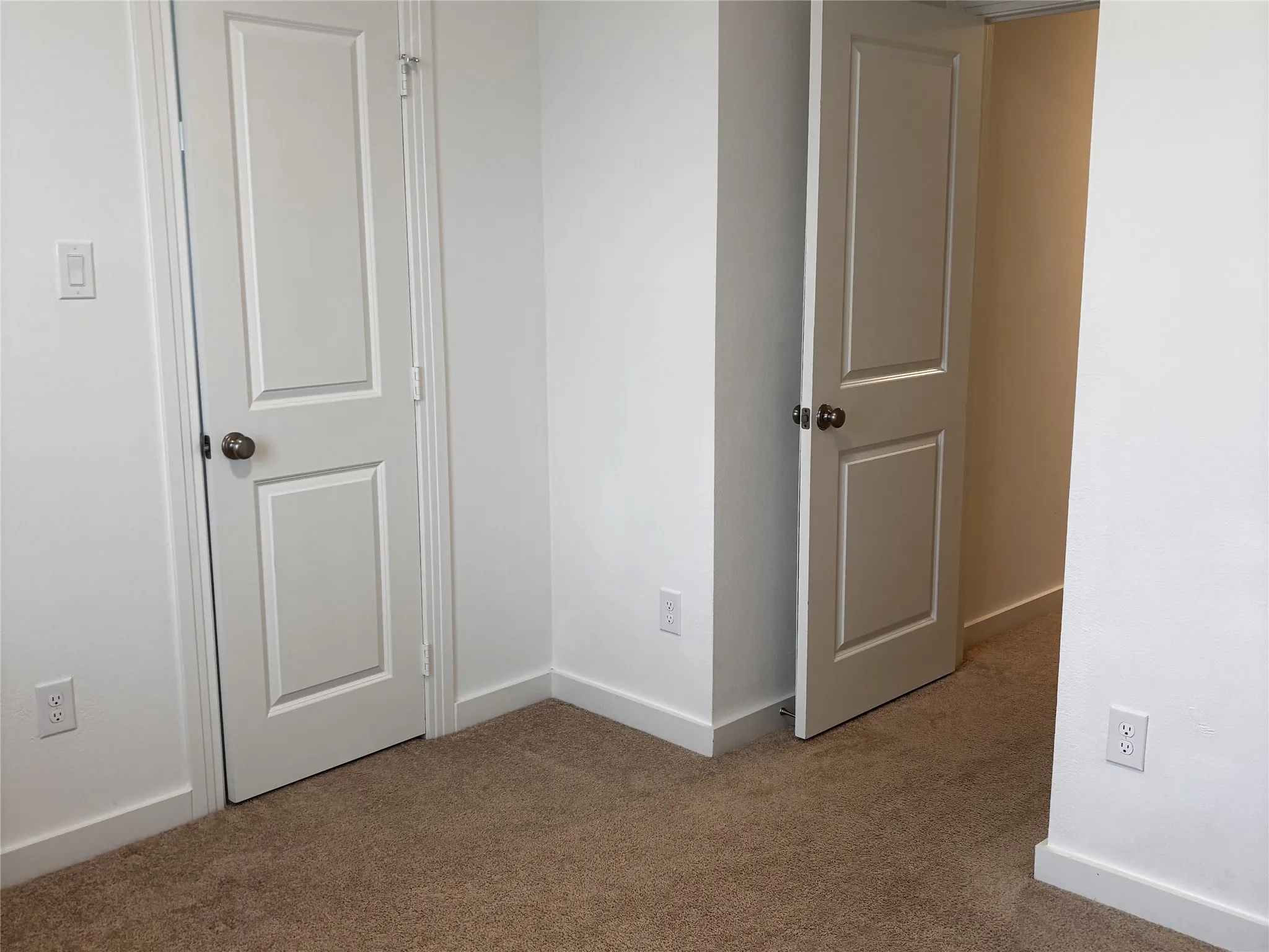 Plush carpet flooring complements white walls