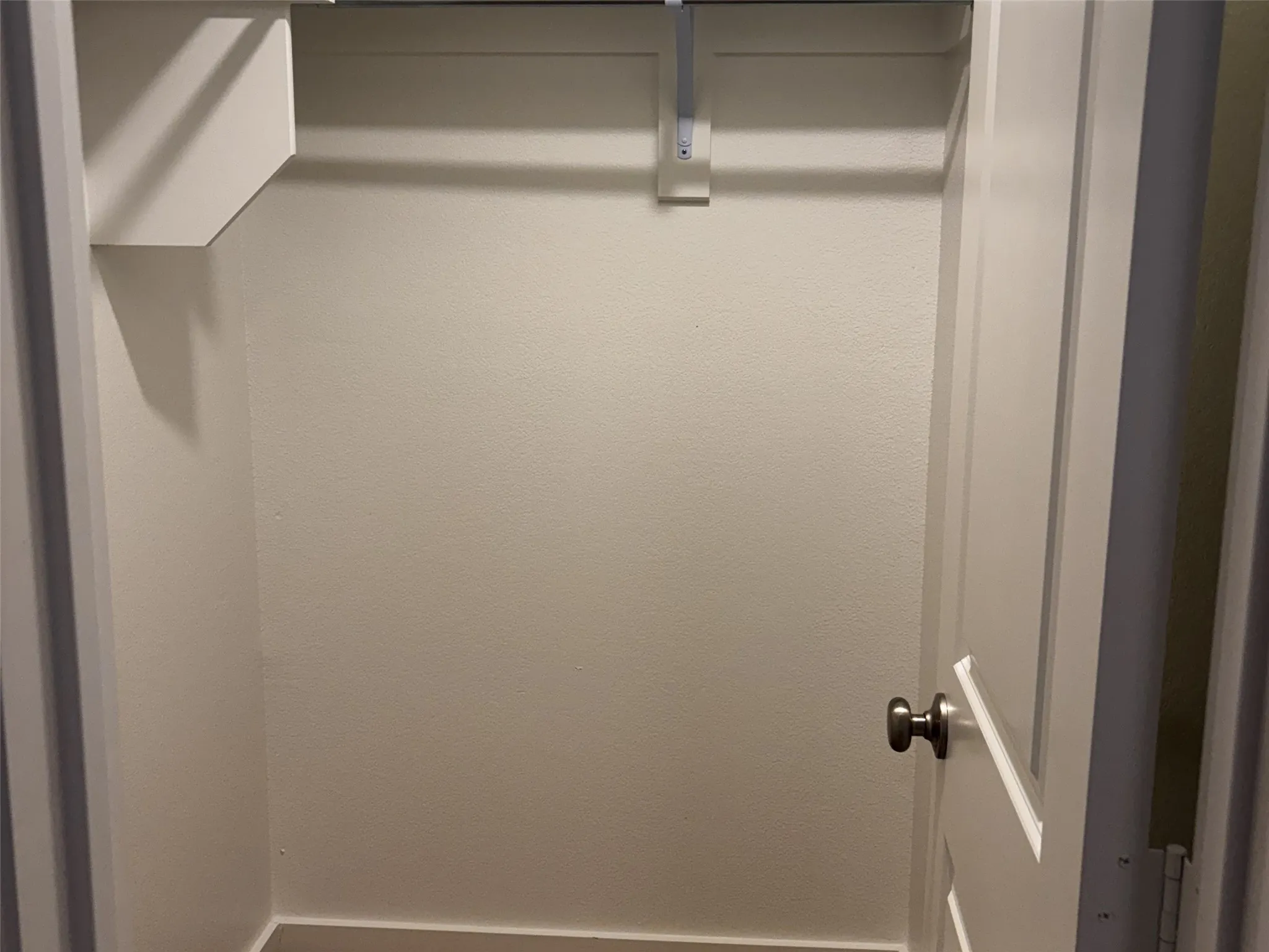 Built-in closet shelving with an integrated hanging rod