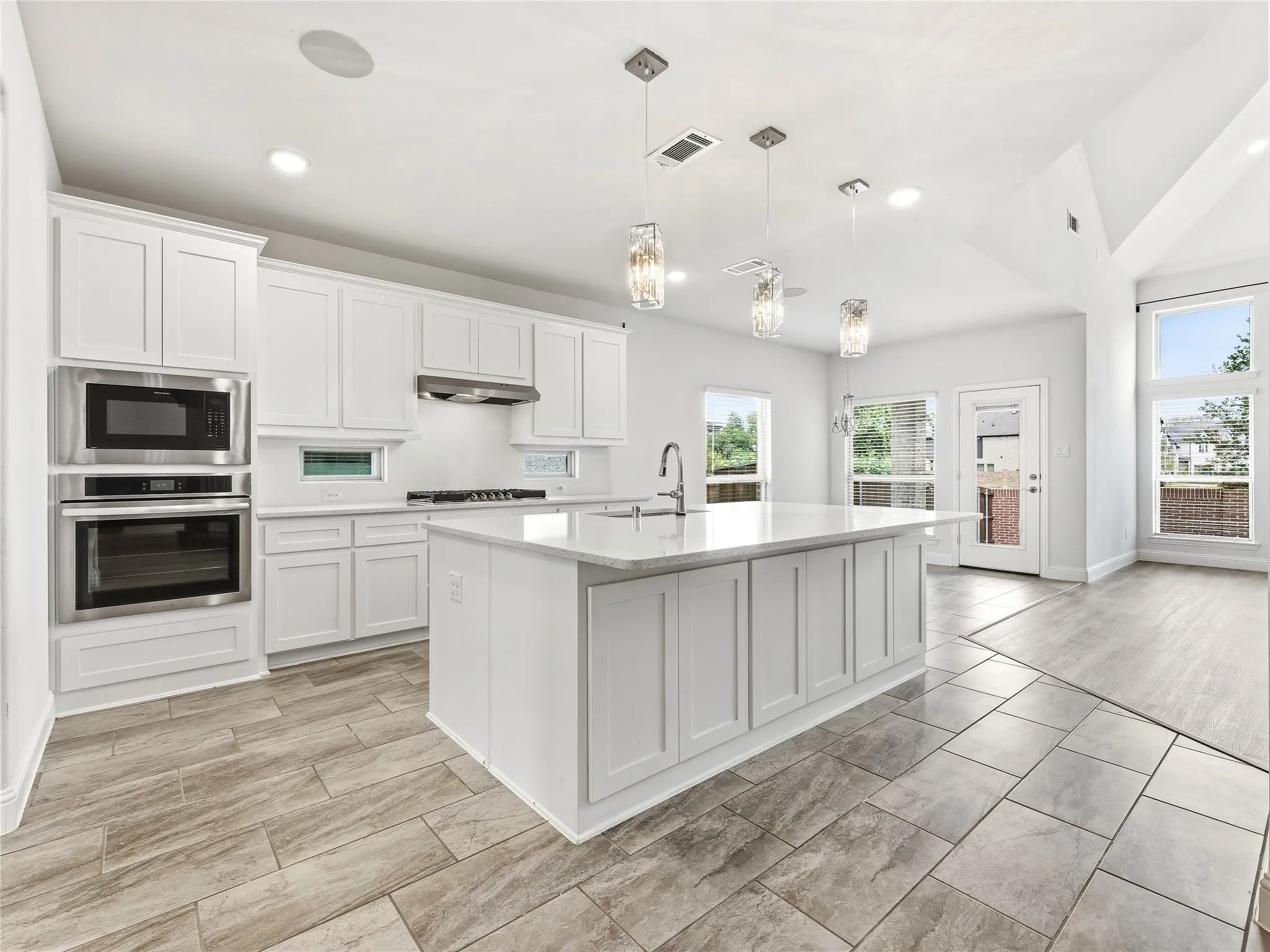 Kitchen featuring a gas cooktop, large island, and tons of storage.
