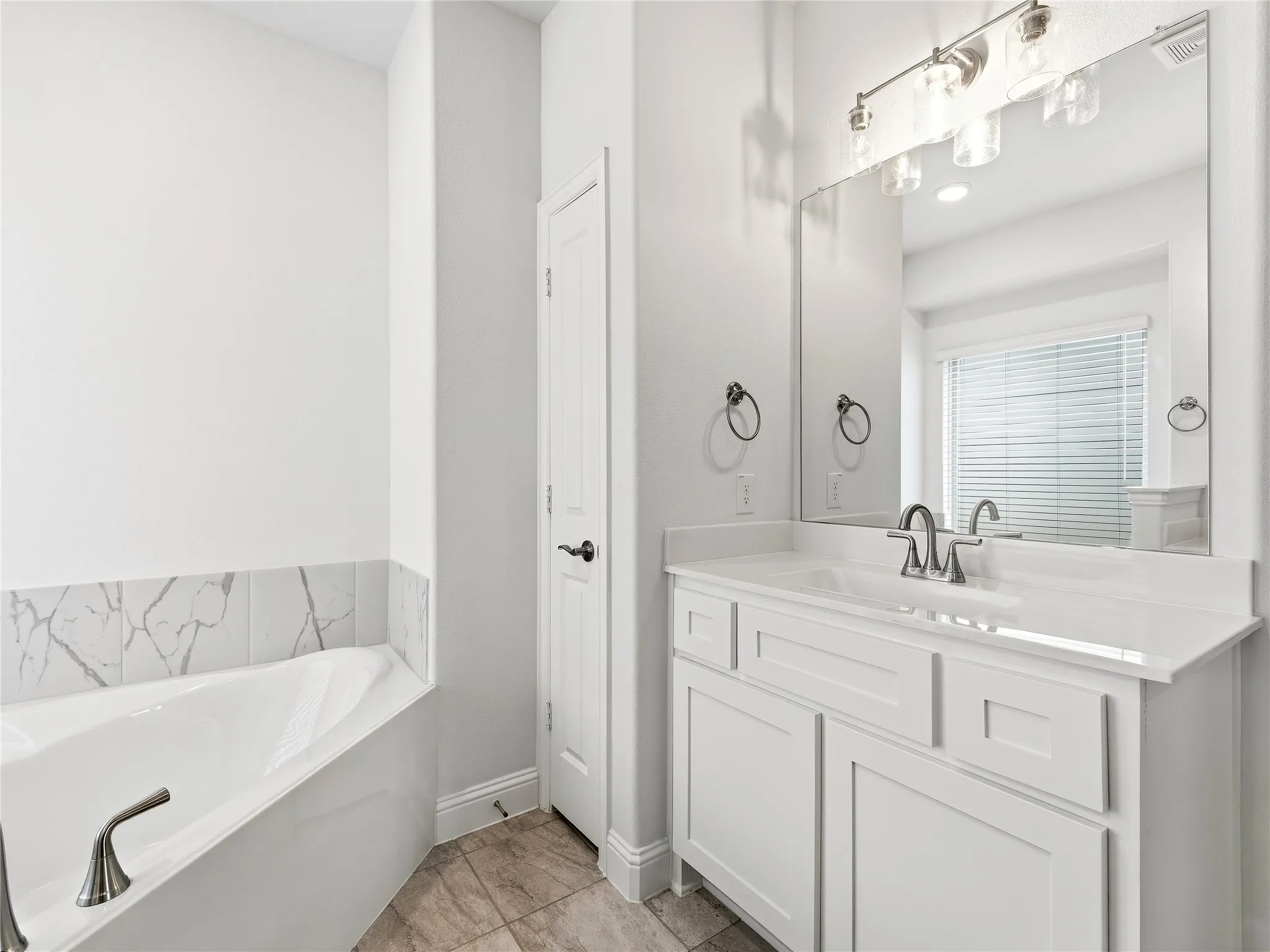 Deep soaking tub with dual vanities