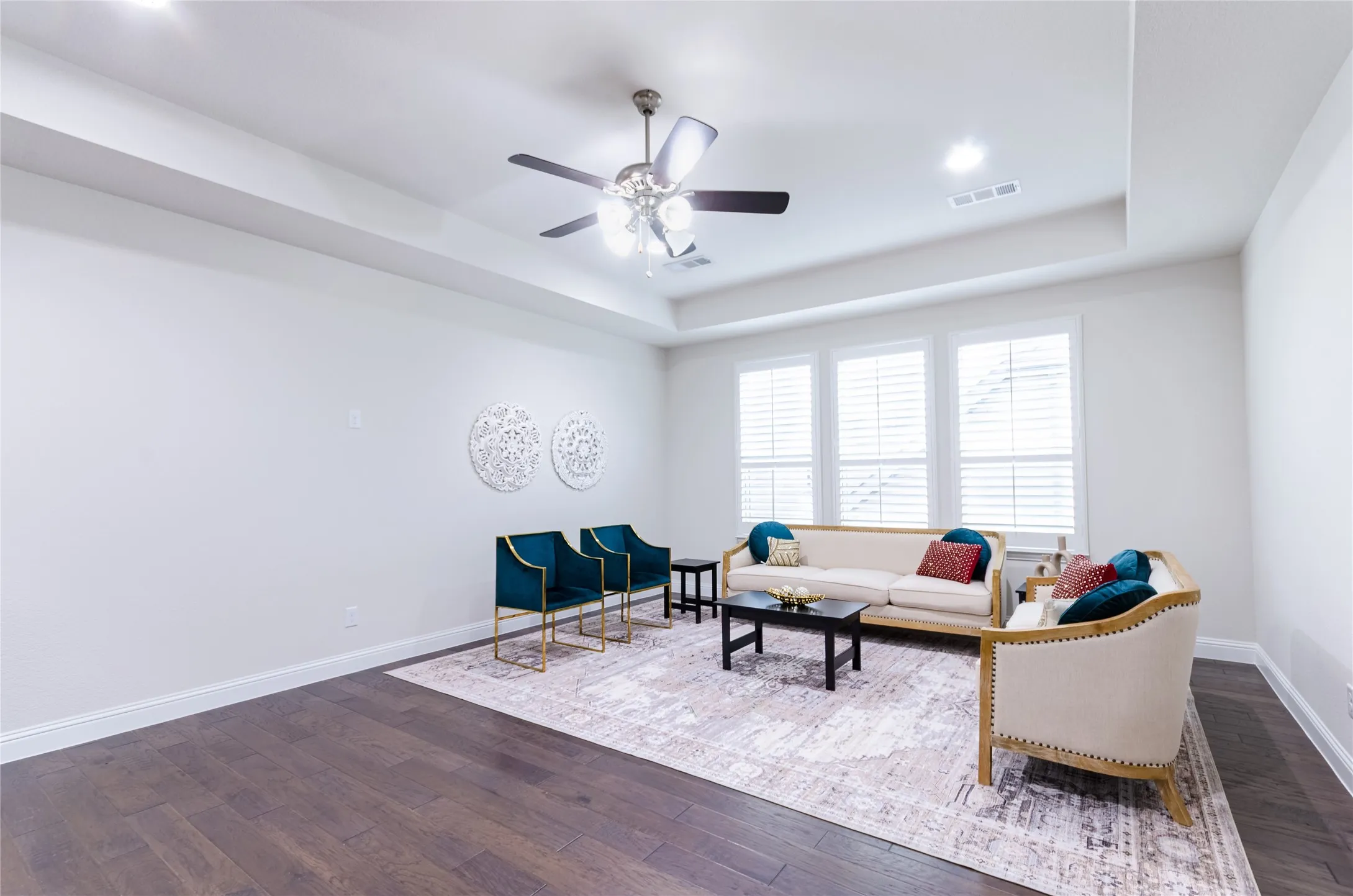 Spacious gameroom or second living area featuring wood-finish flooring and a tray ceiling with recessed lighting