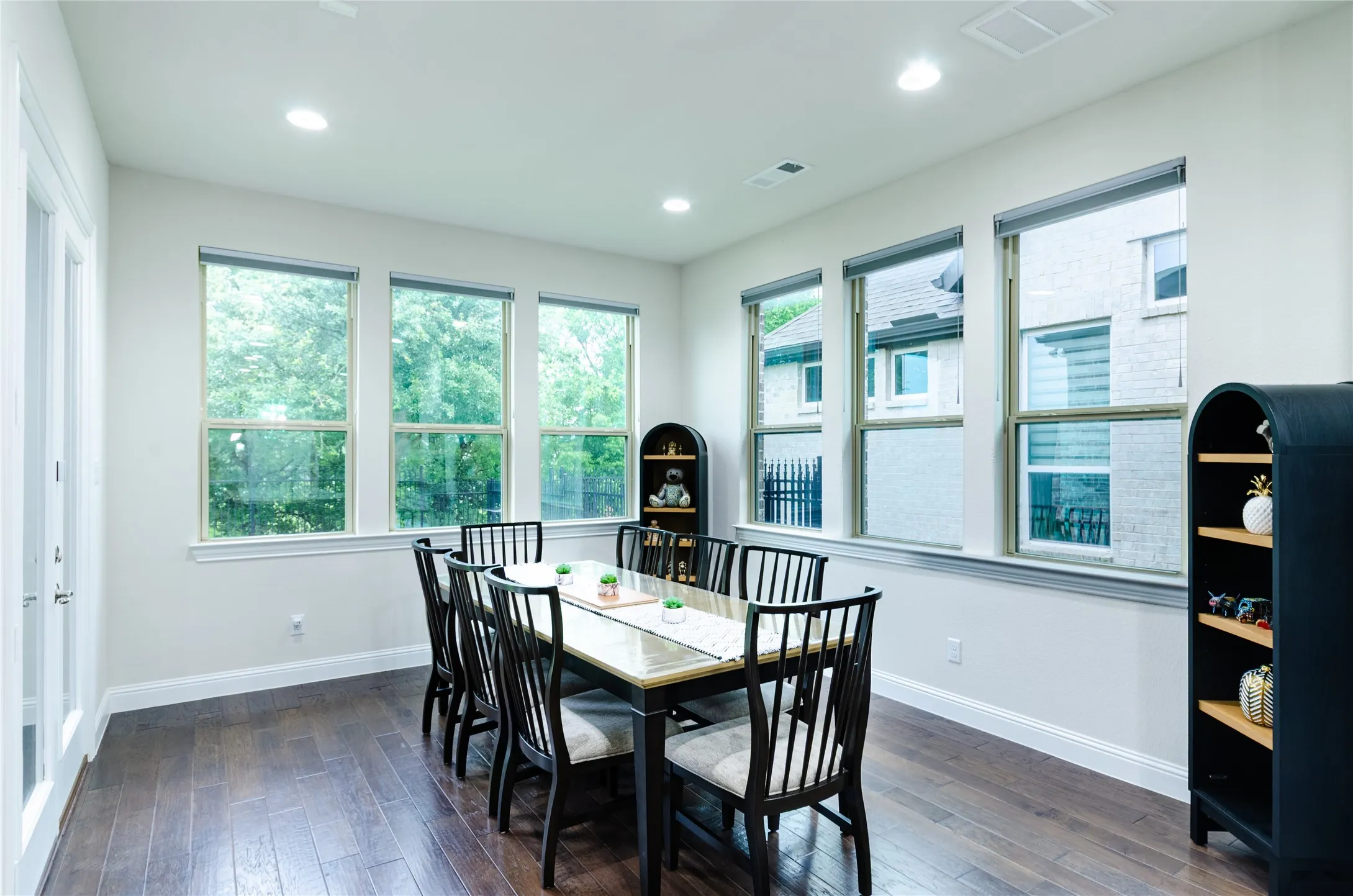 Breakfast area featuring dark wood-finish flooring, recessed lighting, and multiple windows