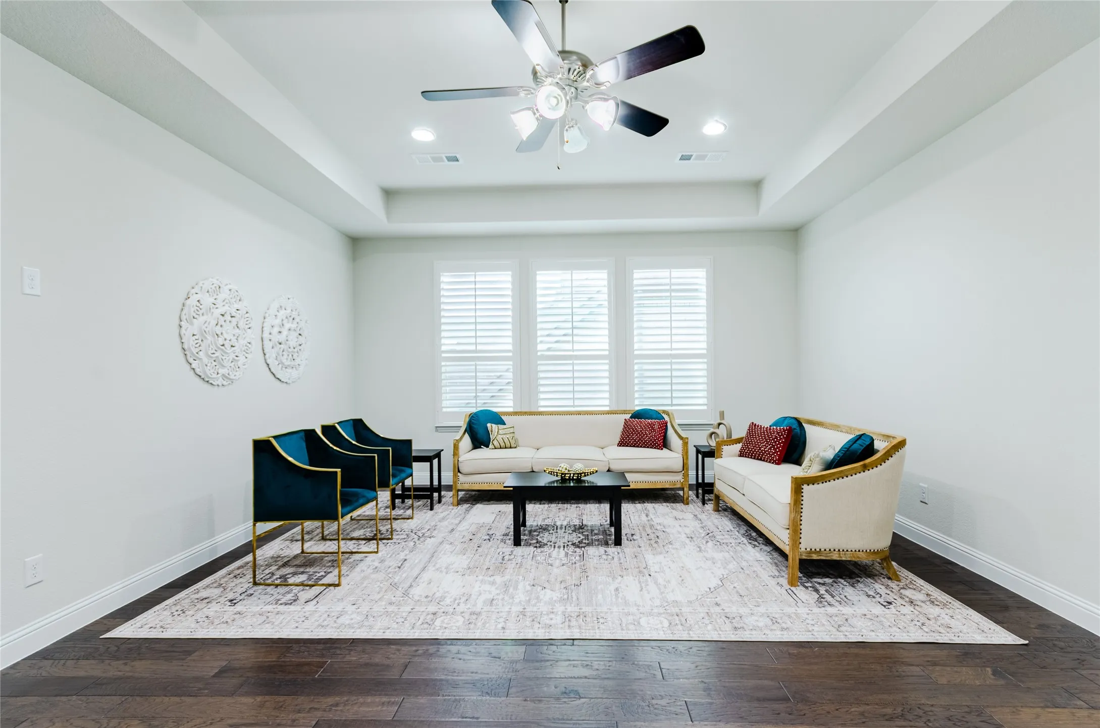 Spacious gameroom or 2nd living room featuring tray ceiling, recessed lighting, wood-finish flooring, and natural light through multiple windows with plantation shutters